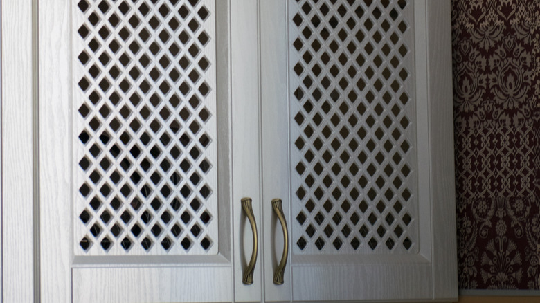 Mesh cabinet with brass handles