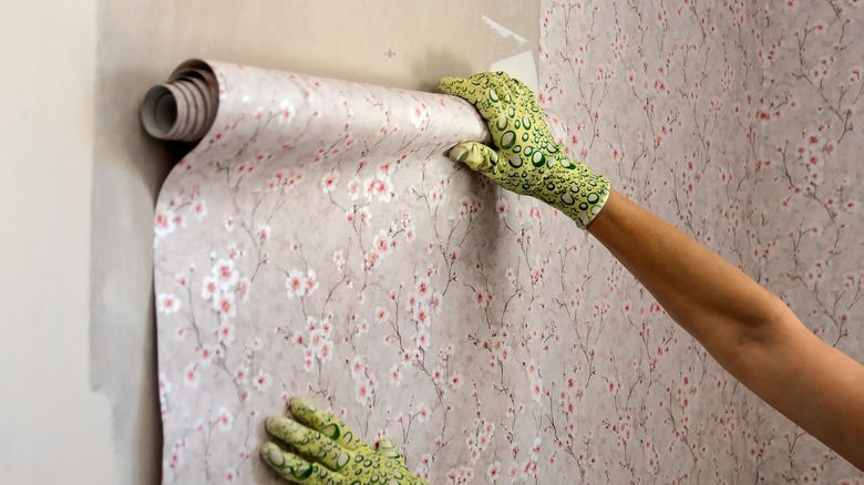 Person applying wallpaper to walls