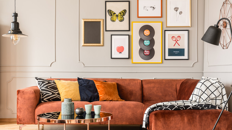 gallery wall with orange couch