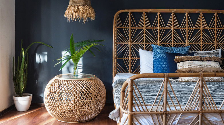 Rattan bed on black wall