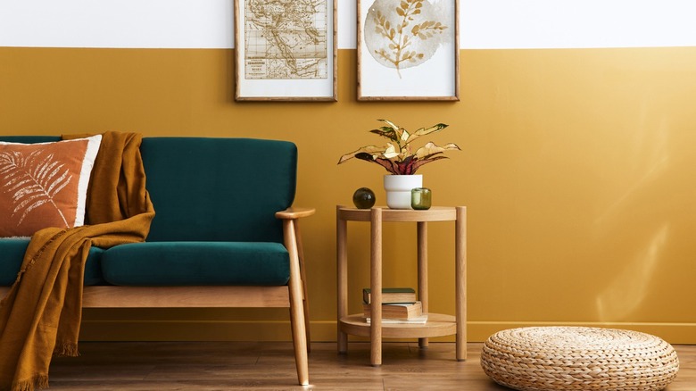 Yellow wall with green sofa