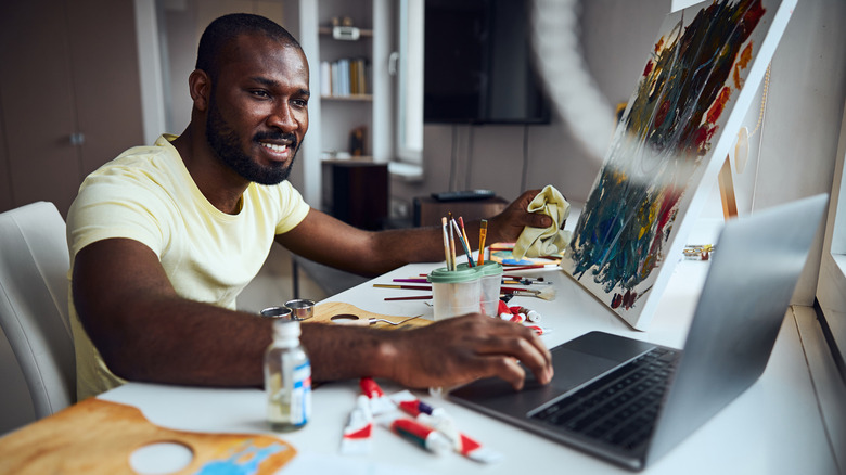 artist looking at a laptop