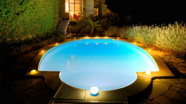 swimming pool with candle at night