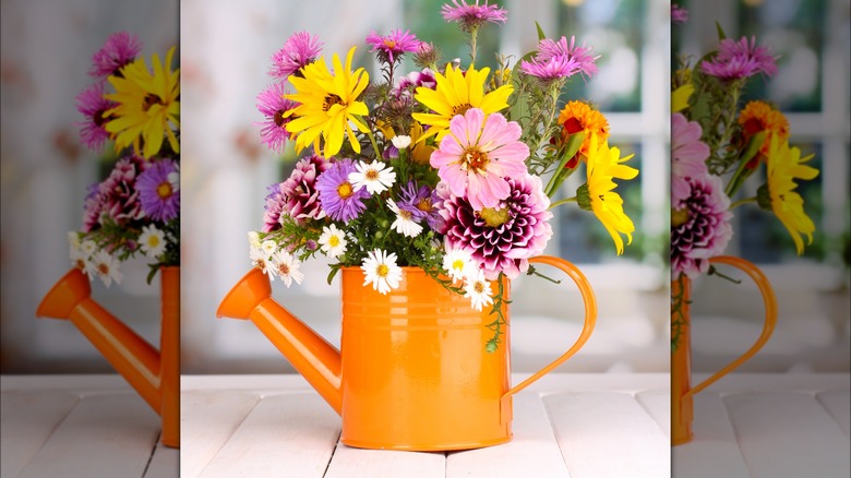 watering can filled with wild fowers