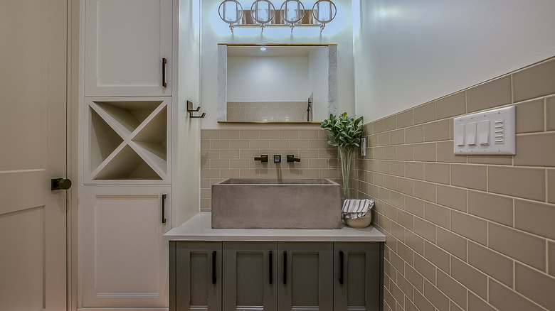 Gray bathroom with tall cabinet