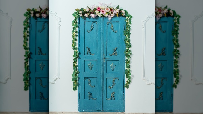 flowers above a blue door