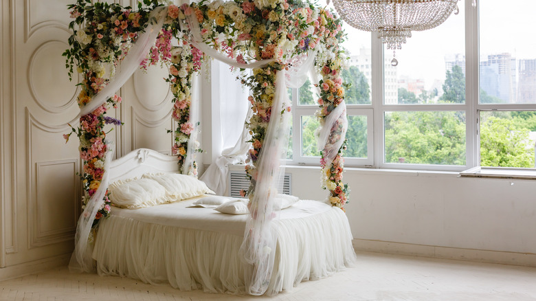 pink flowers around canopy bed