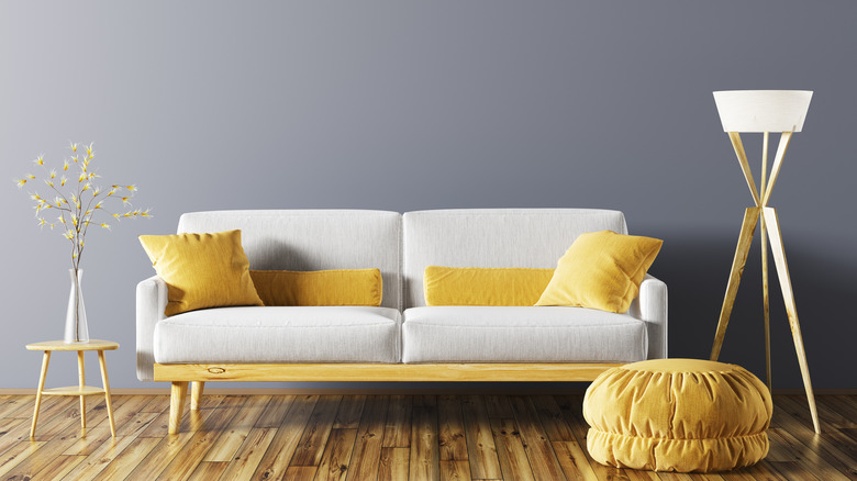 Yellow ottoman and white sofa