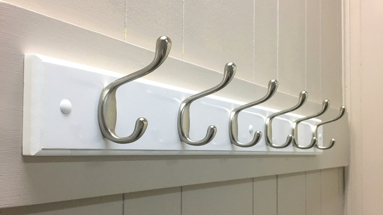 colorful aprons on wall hooks