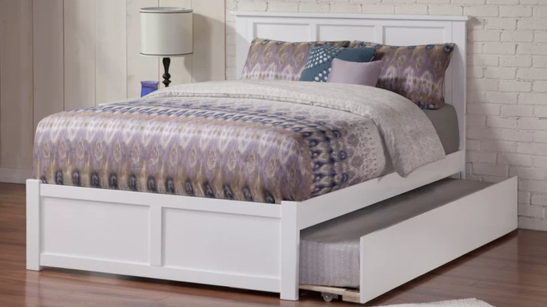 white full-sized trundle bed