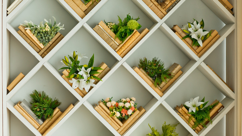 books and flowers in bookcase