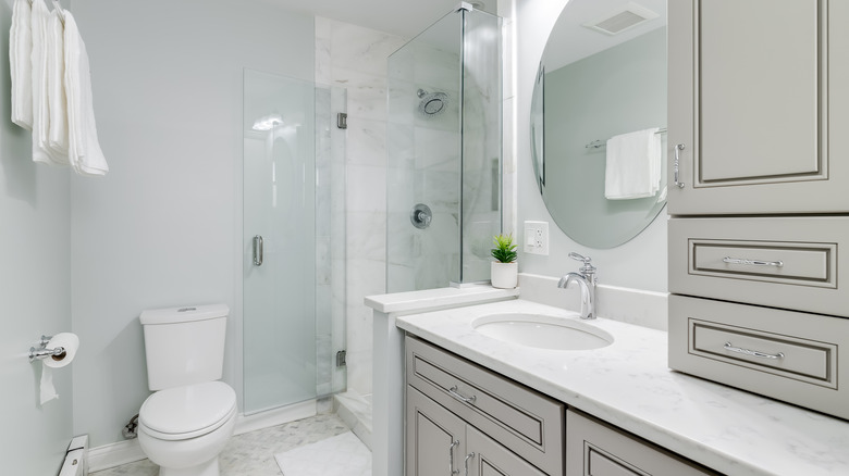 White bathroom with gray cabinets