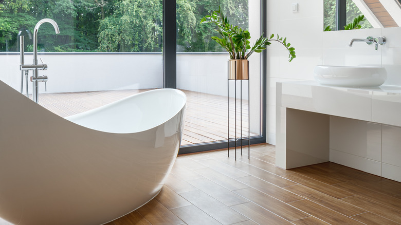 wooden bathroom floor with tub