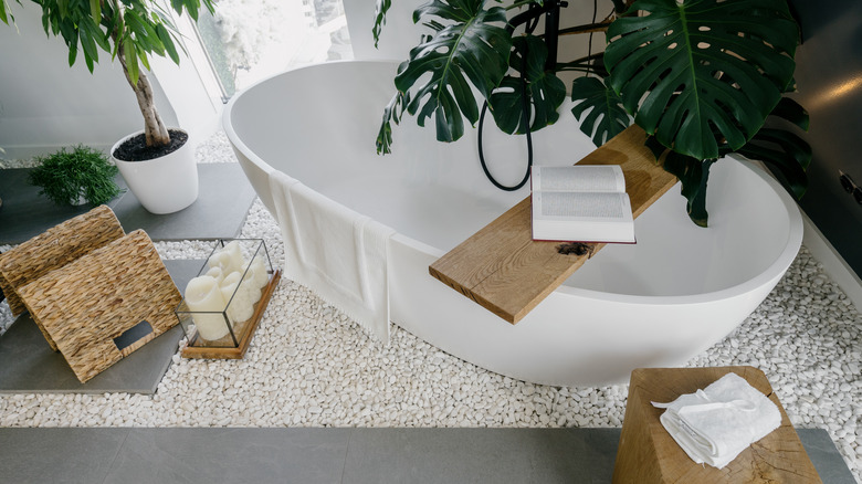 wooden shelf over white bathtub