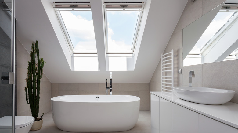 skylights above white bathtub