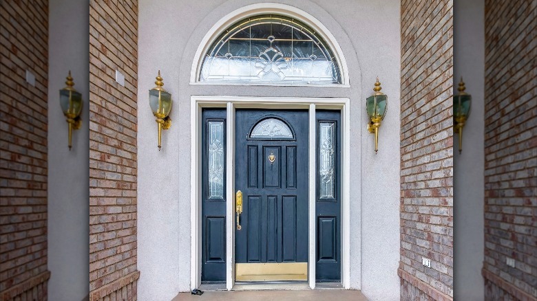 arched window above blue door