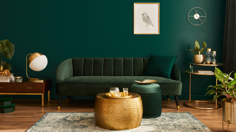 Green sofa with gold décor