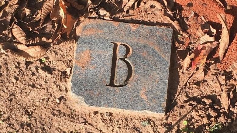 stone carved with letter B
