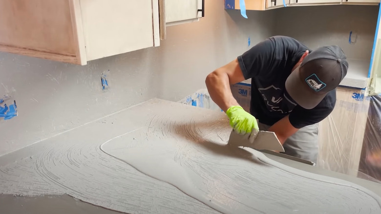 man installing concrete overlay