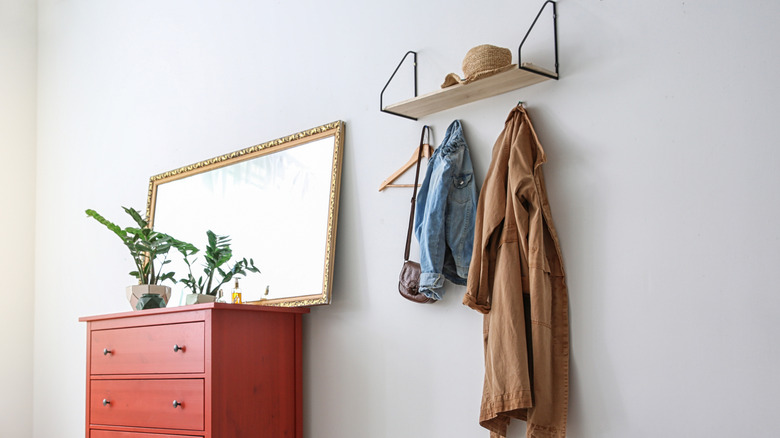 hooks underneath a floating shelf