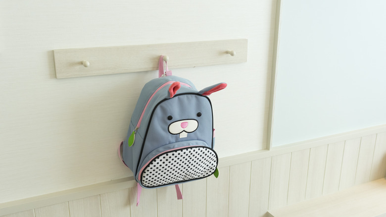 child's backpack hanging on wall