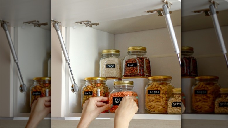 flip open cabinets with glass jars