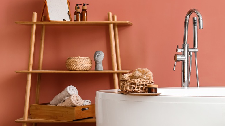 shelving unit behind white bathtub