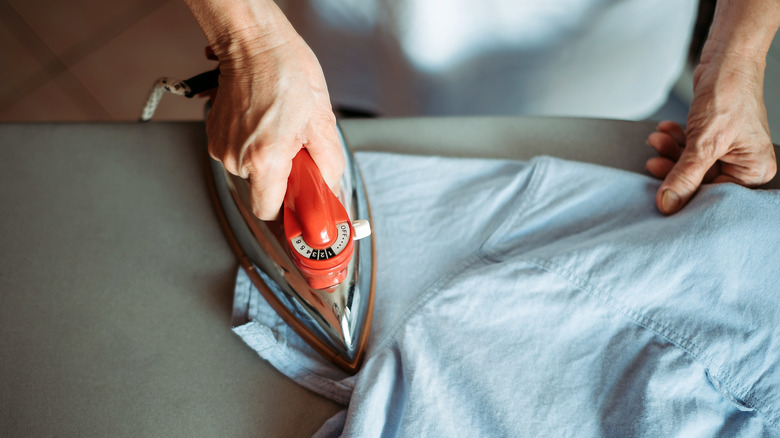 hands ironing a shirt