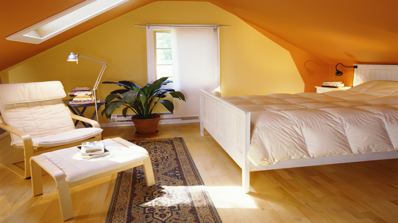 A bedroom with bright yellow walls and an orange ceiling