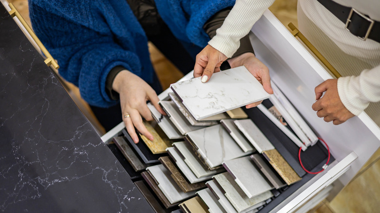 Two people looking at stone countertop samples in a store