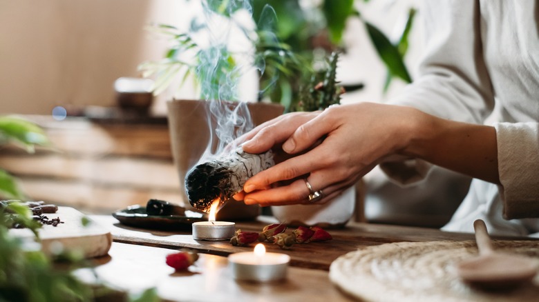 person burning herbs