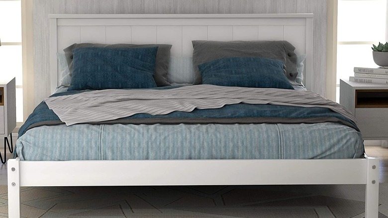 White headboard with blue bedding