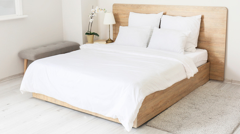 White bedding and wooden headboard