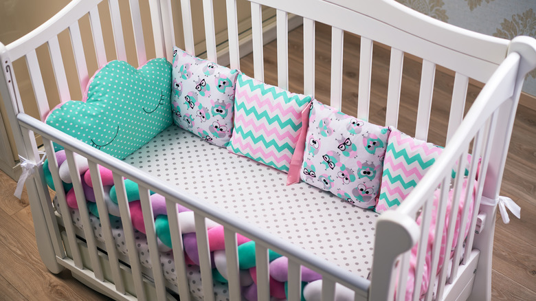 Baby crib with colorful pillows