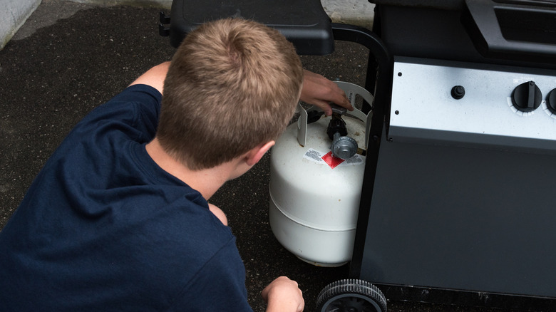 checking propane tank on grill