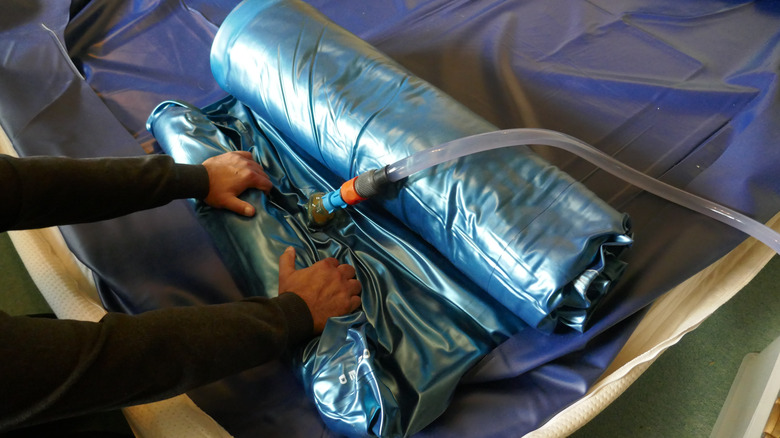 Person dismantling waterbed