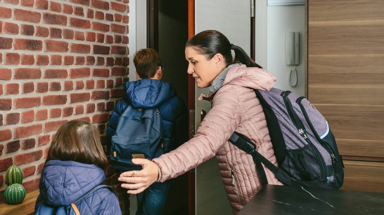 woman ushering prepared kids out