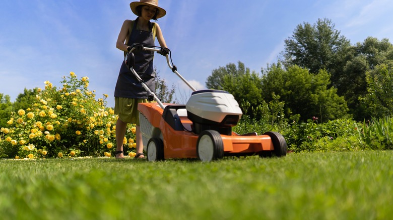 Person mowing grass