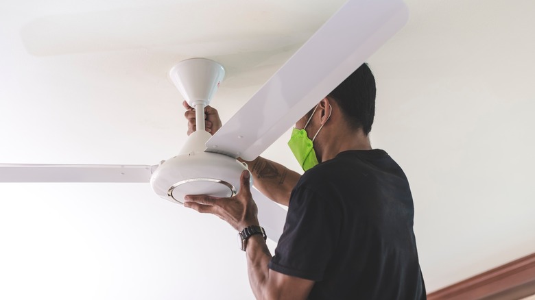 Man installing a ceiling fan