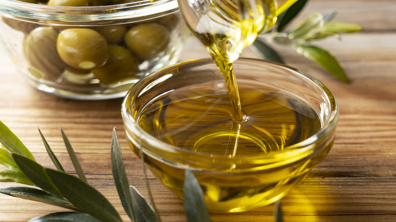 Person pouring olive oil