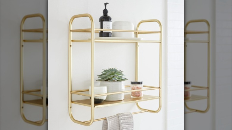 gold shelf with hanging towel