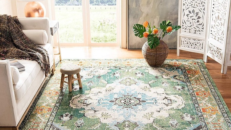 Green rug with white couch