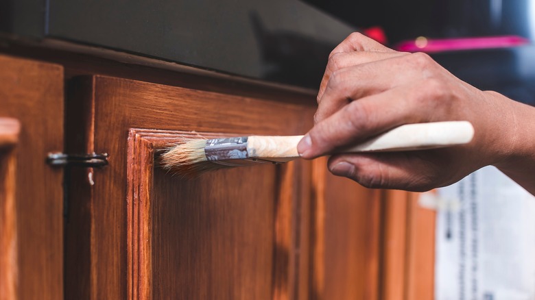 man repainting kitchen cabinets