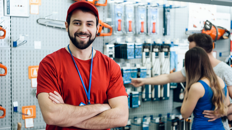 Man assisting hardware shoppers