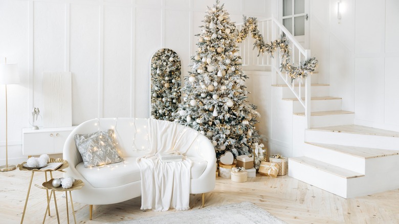 Metallic Christmas tree in white living room with minimal decor