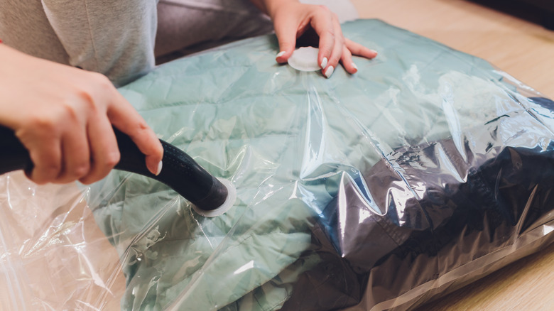 person vacuum sealing clothing