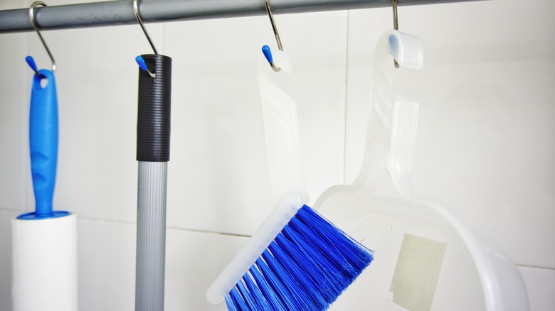 cleaning tools hanging on hooks