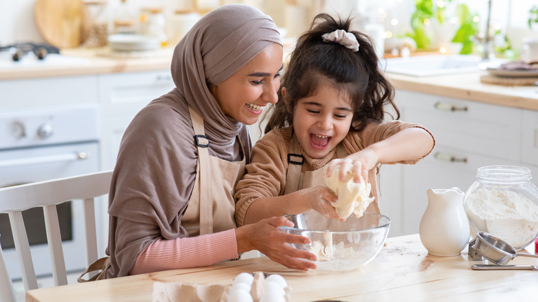 mother and daughter preparing food