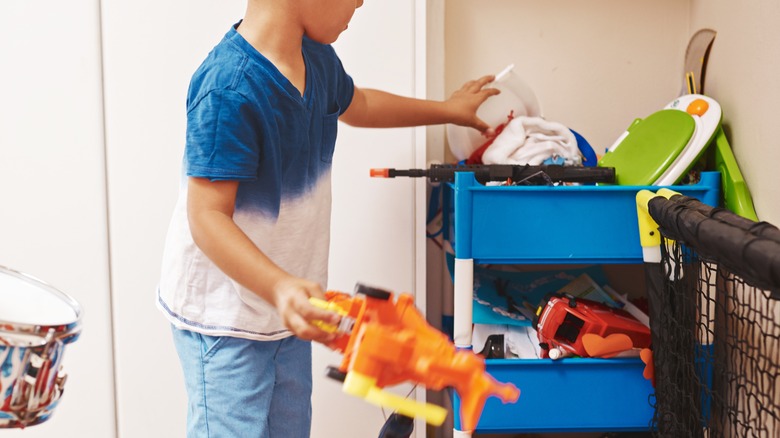 Kid pulling toys out of stackable bins