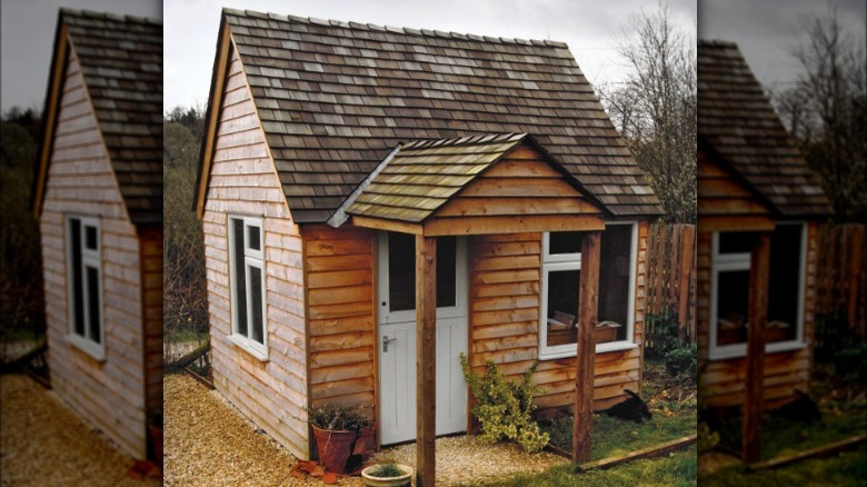 small wooden cottage in backyard